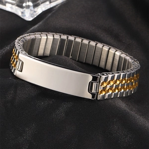 Detail of silver polished metal plate on gold and silver stretch watch band bracelet