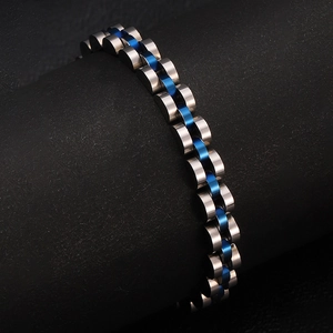 Detailed close-up of blue and silver stainless steel link bracelet on a display stand