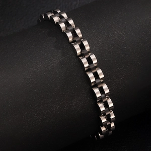 Close-up of two-tone stainless steel president link bracelet on a black display stand