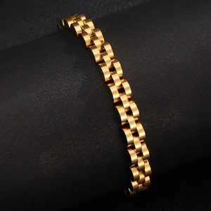 Macro view of polished gold stainless steel bracelet showing dense link texture