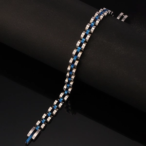 Macro detail of three-row stainless steel watch strap bracelet in silver and blue