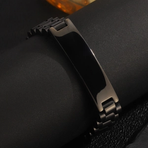 Detail view of the sleek black stainless steel ID plate and watch-link bracelet design
