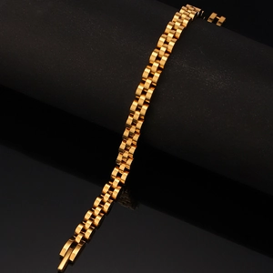 Macro detail of gold stainless steel watch band with polished three-link president style