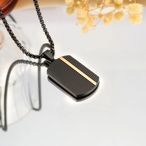 Men's black stainless steel dog tag necklace with gold accent and vertical stripes