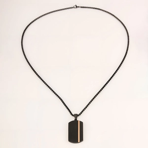 Detail shot of black stainless steel dog tag pendant with vertical stripes and rose gold bar