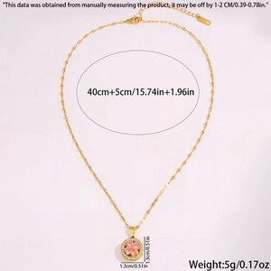 Detail view of gold clover pendant with pink inlay and sparkling micro-pave crystals
