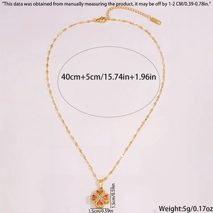 Detail view of rotating clover pendant with orange zircon and stainless steel chain