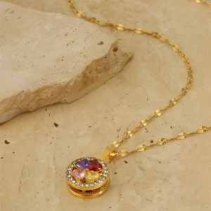 Macro view of rotating four-leaf clover pendant with colorful crystals and diamonds