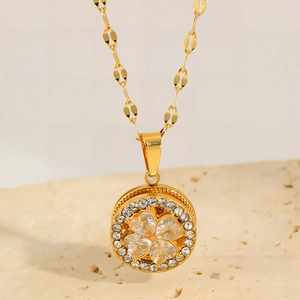 Elegant gold titanium steel necklace featuring a diamond-studded four-leaf clover pendant