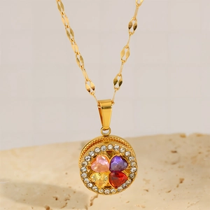 Detailed close-up of a gold-plated necklace featuring a four-color heart petal clover pendant