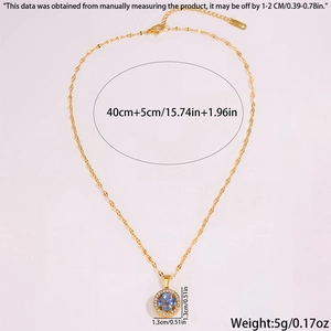 Detail view of gold clover pendant with blue petals and sparkling crystal border