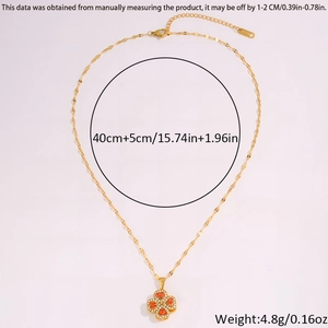 Close-up of rotatable clover necklace with orange-red petals and white crystals