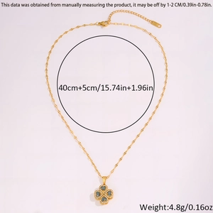 Detail view of gold clover pendant with blue gemstones and adjustable necklace chain length