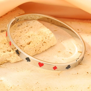 Macro shot of poker patterns with red and black enamel on a 18k gold plated steel bangle