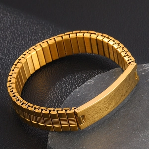 Detail of gold stretch watch band bracelet with a polished engravable curved plate