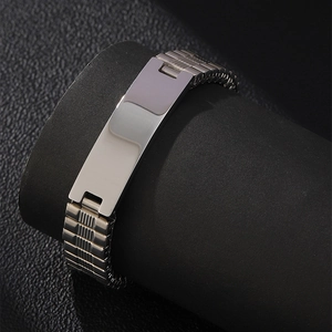 Macro view of men's stainless steel ID bracelet with adjustable watch strap style chain
