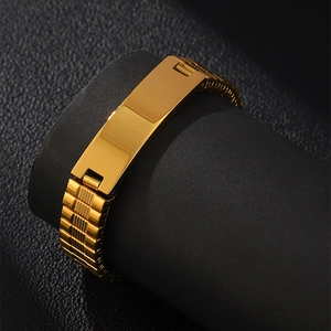 Detailed close-up of golden stainless steel watch-style bracelet on black display