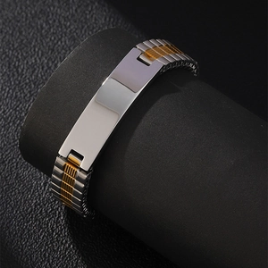Detail of two-tone stainless steel strap bracelet with a silver engravable metal plate