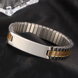Close-up of two-tone gold and silver stretch metal watch band bracelet with a polished ID plate