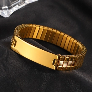 Macro shot of gold elastic watch band bracelet with blank brushed rectangle metal plate