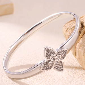 Macro shot of titanium steel clover bracelet with sparkling cubic zirconia inlay detail
