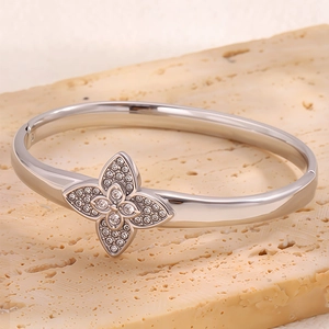 Macro detail of silver titanium clover bracelet with sparkling micro-pave zircons