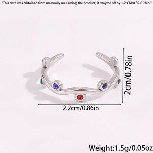 Macro detail of wave-shaped ring featuring rainbow zircon stones and silver steel finish