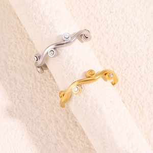 Detailed macro view of matte finish leaf rings with embedded colorful zircon stones