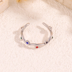 Rainbow zircon leaf open ring in silver stainless steel on stone texture background