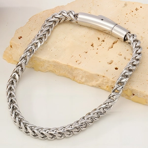 Detailed view of silver stainless steel wheat chain bracelet with industrial clasp