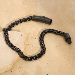 Close-up of black titanium steel woven dragon bone bracelet with cylindrical magnetic clasp