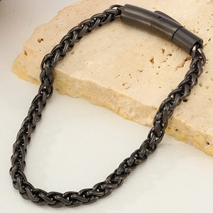 Macro view of gunmetal titanium chain link bracelet with premium snap buckle on stone
