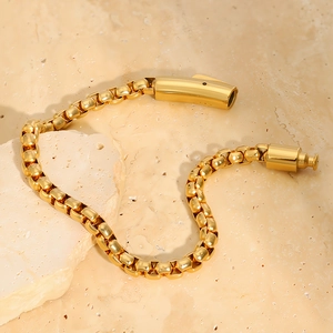 Close-up of golden stainless steel box chain bracelet with secure cylinder clasp