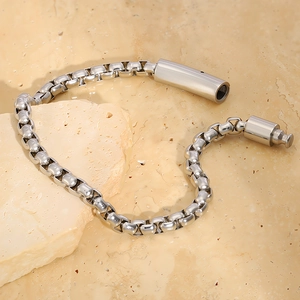 Macro detail of silver stainless steel box chain bracelet with unique cylindrical clasp
