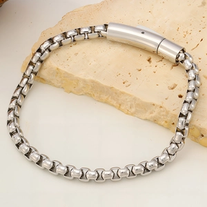 Close-up of polished titanium steel box chain bracelet with secure cylinder clasp