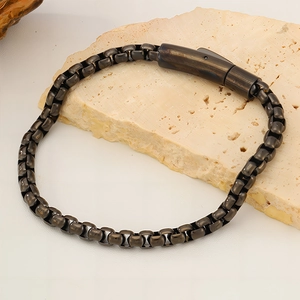 Macro view of vintage bronze box chain bracelet with durable industrial plug-in clasp