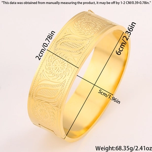Macro detail of Chinese style gold titanium steel bangle with floral patterns and hinge