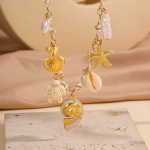 Détail du collier de plage tissé avec breloques d'étoile de mer, tortue d'or et perles