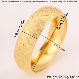 Detailed view of 1.9cm wide gold titanium bangle with frosted starburst grid texture