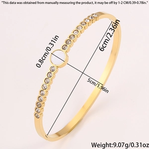 Macro view of gold stainless steel bangle with shell inlay and detailed dimensions