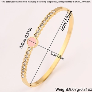 Detail view of gold titanium steel bangle showing pink circular charm and dimensions