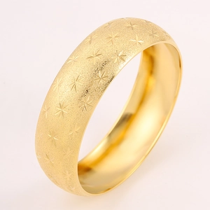 Matte gold-plated titanium steel bangle with engraved star patterns and polished inner band