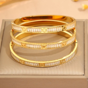 Brazaletes de acero de titanio dorado con trébol y corazón y circonitas rectangulares