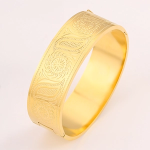 Luxurious gold titanium steel bracelet with embossed floral patterns in a 45-degree view