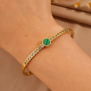 Elegant gold titanium bracelet with green malachite stone and sparkling zircons for women