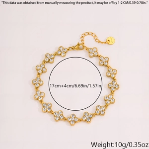 Detail of gold clover bracelet with white rhinestones and logo tag showing S.steel mark