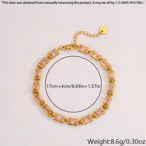 Detailed macro view of gold plated stainless steel bracelet with pink zirconia stones