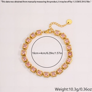 Macro detail of gold stainless steel bracelet with square pink zircon stones and clasp