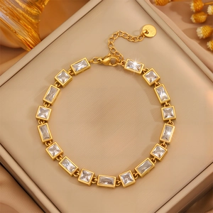 Detail of gold plated stainless steel bracelet with cubic zirconia on a jewelry tray