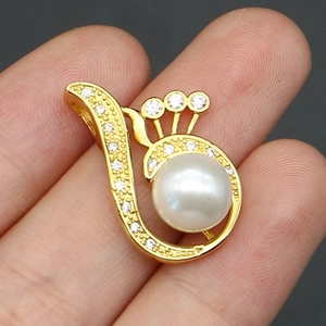 Detailed close-up of a golden peacock wing pendant featuring white pearl and zircon accents